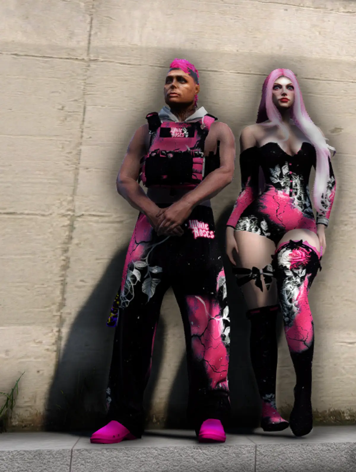 Two DRILL UK White Roses members in matching pink and black outfits stood against a concrete wall