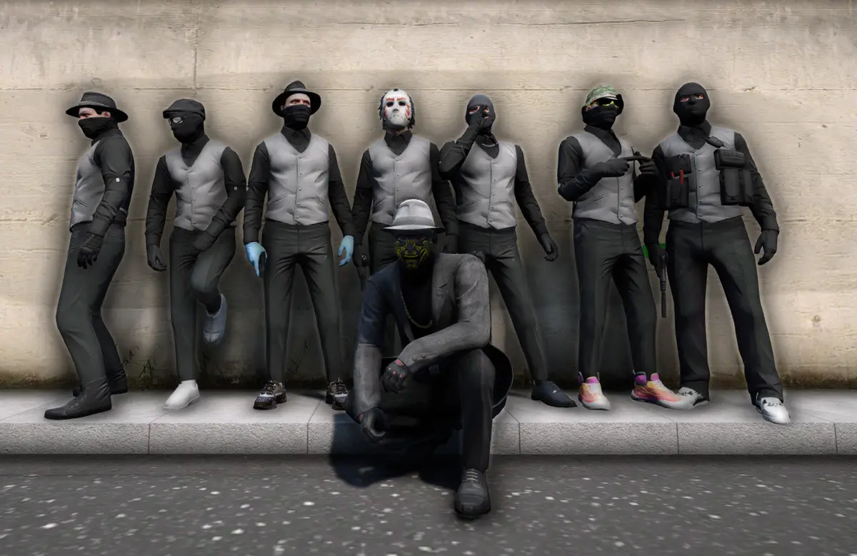 Eight masked DRILL UK players in grey waistcoats and black shirts against a stone wall, seven stood in a line and one crouched in front